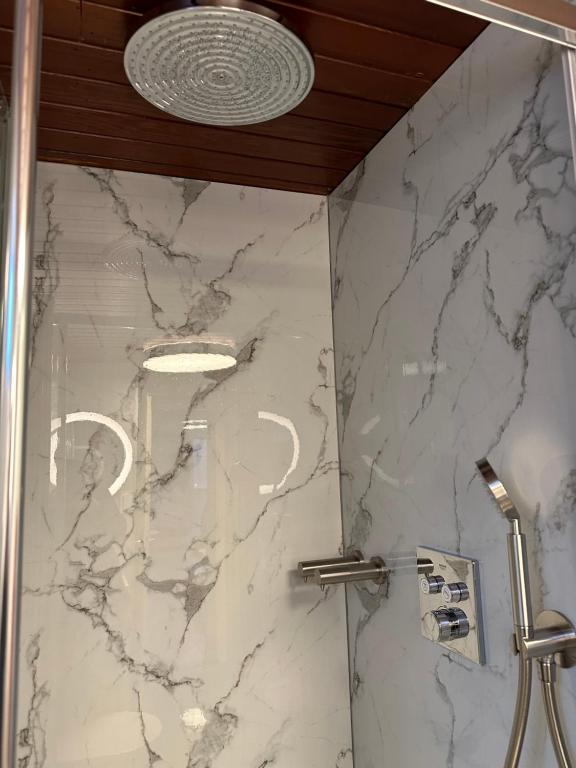 a bathroom with a marble shower with a ceiling at Boat no Breakfast in Amsterdam