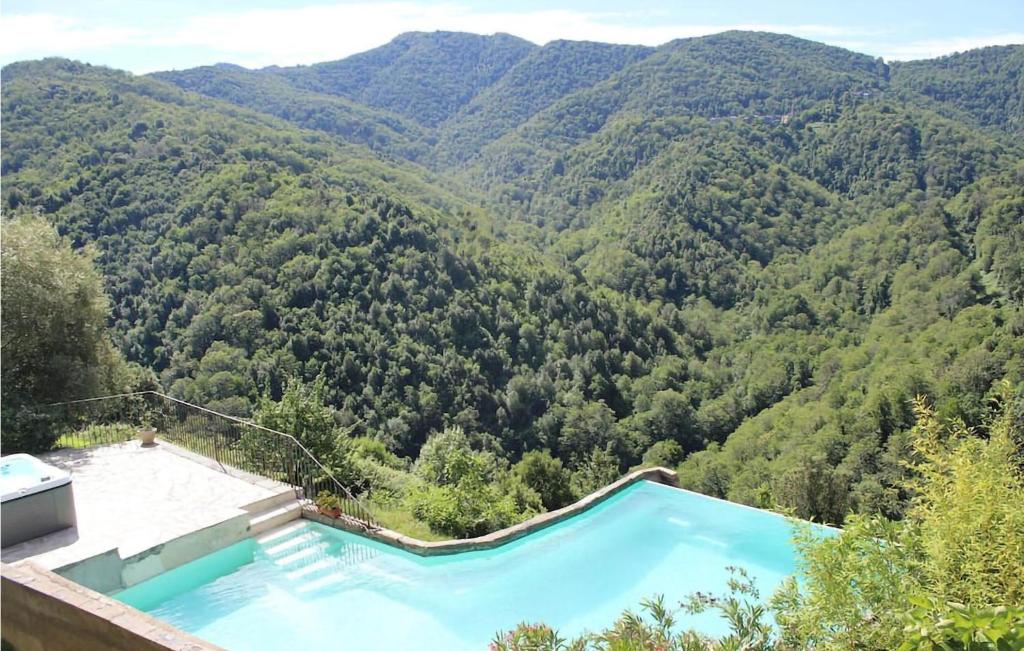 a swimming pool with mountains in the background at 2 Bedroom Stunning Apartment In Carcheto Brustico in Carcheto