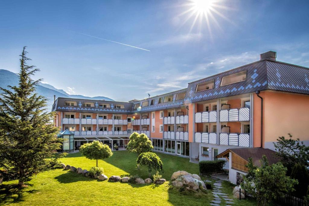 una vista exterior de un hotel con jardín en Aktiv & Wellnesshotel Zentral, en Prato allo Stelvio