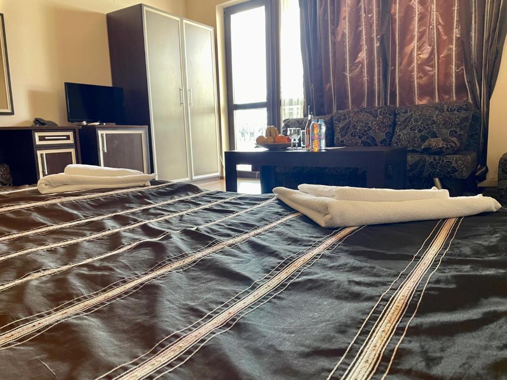 A bed or beds in a room at At the American's Hotel