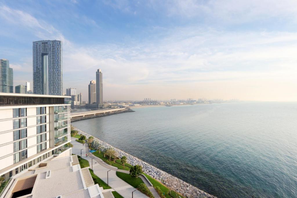 a view of the water from a building at Upgraded 2BR Plus Maid's Room with Sea View - Livbnb Bluewaters Suites in Dubai