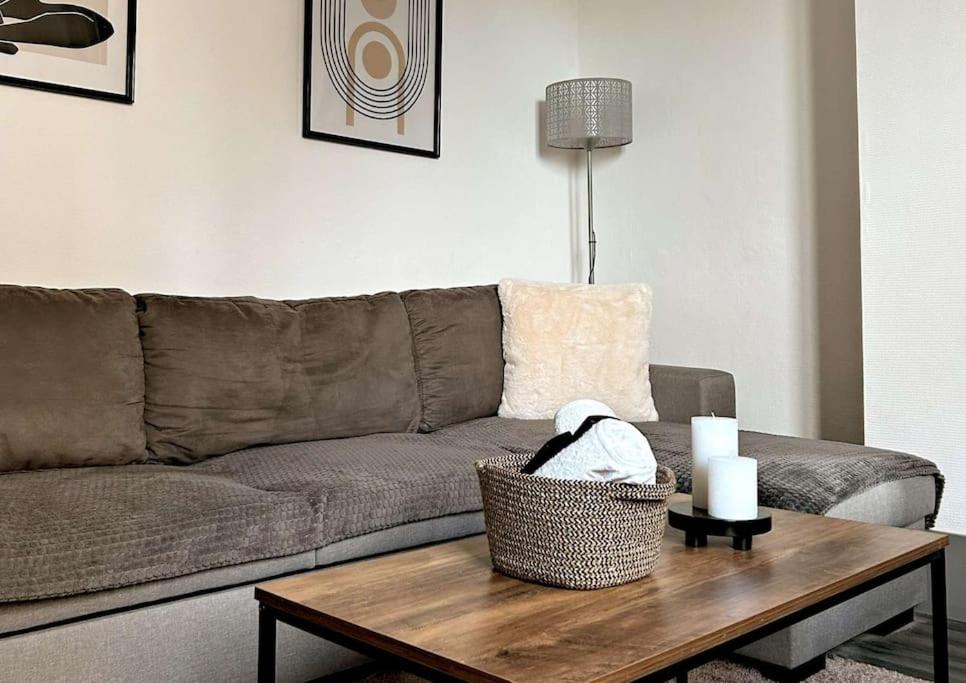 a living room with a couch and a table with candles at Cosy Dunkerquois in Dunkerque