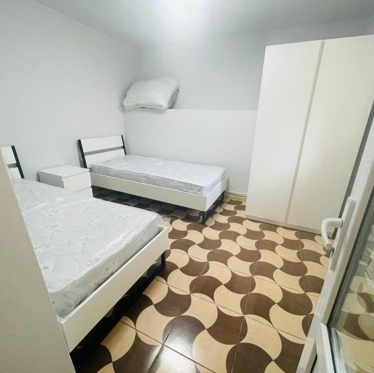 a room with two beds and a checkered floor at Аренда Квартиры в Ереване (Зейтун) - Apartment Rent in Yerevan (Zeytun) in Yerevan