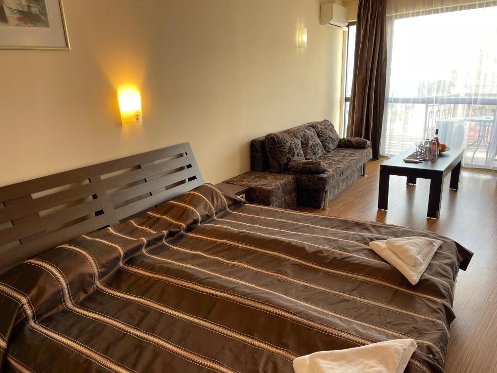 A bed or beds in a room at At the American's Hotel
