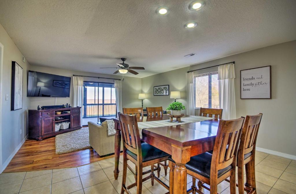 a kitchen and dining room with a table and chairs at Ozarks Vacation Rental Condo with Lake View! in Lake Ozark