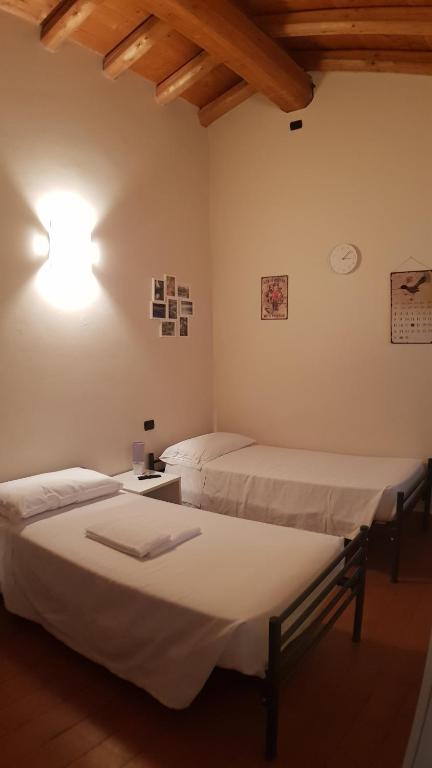 Postel nebo postele na pokoji v ubytování Ostello Molino Di Basso