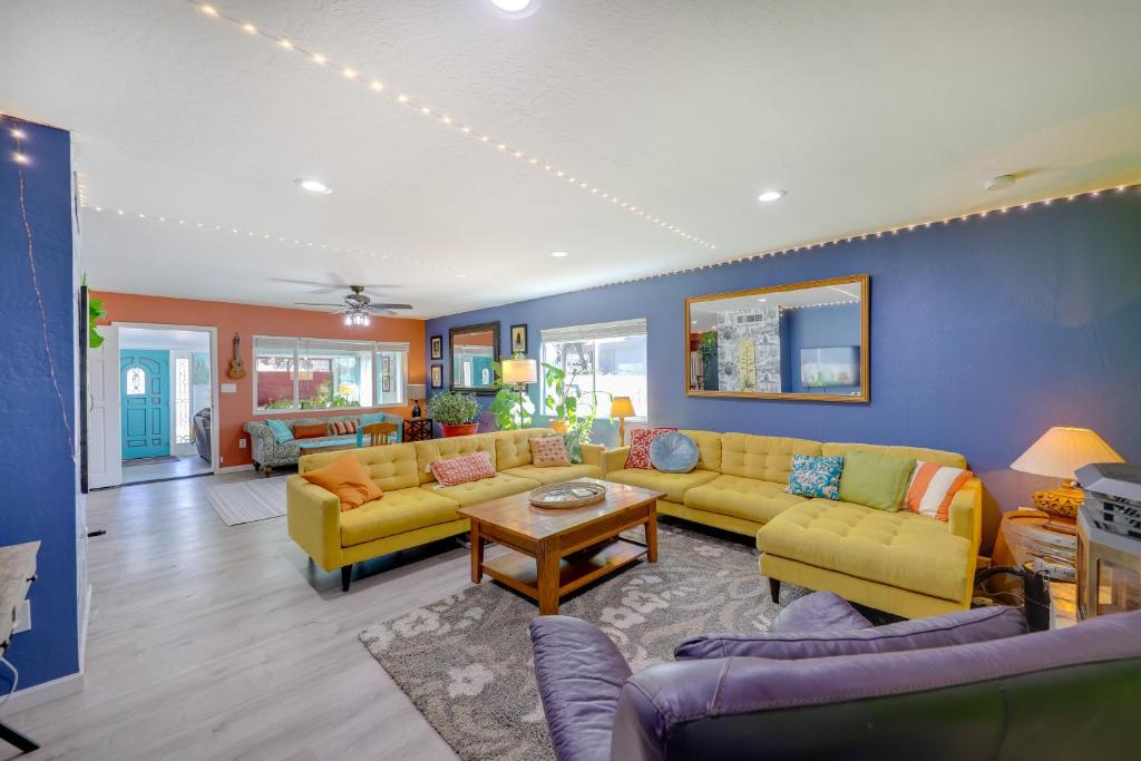 a living room with yellow couches and a table at Payson Vacation Rental with Private Patio! in Payson