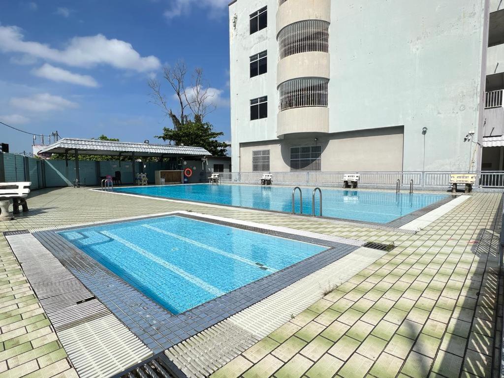 a large swimming pool in front of a building at Batu Pahat Airbnb Homestay Empire 9 in Batu Pahat