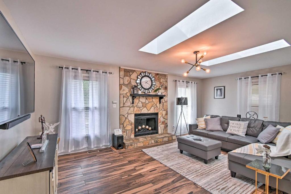 a living room with a couch and a fireplace at Fayetteville Vacation Rental with Sunroom and Yard! in Fort Bragg