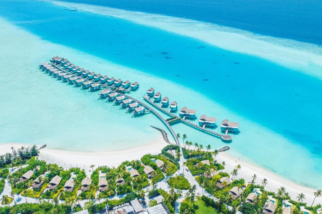 an aerial view of a beach with a marina at Hard Rock Hotel Maldives in South Male Atoll