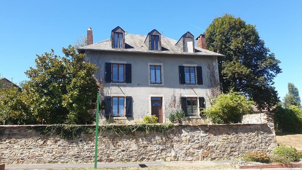 an old house on top of a stone wall at Maison de bourg in Saint-Maurice-les-Brousses