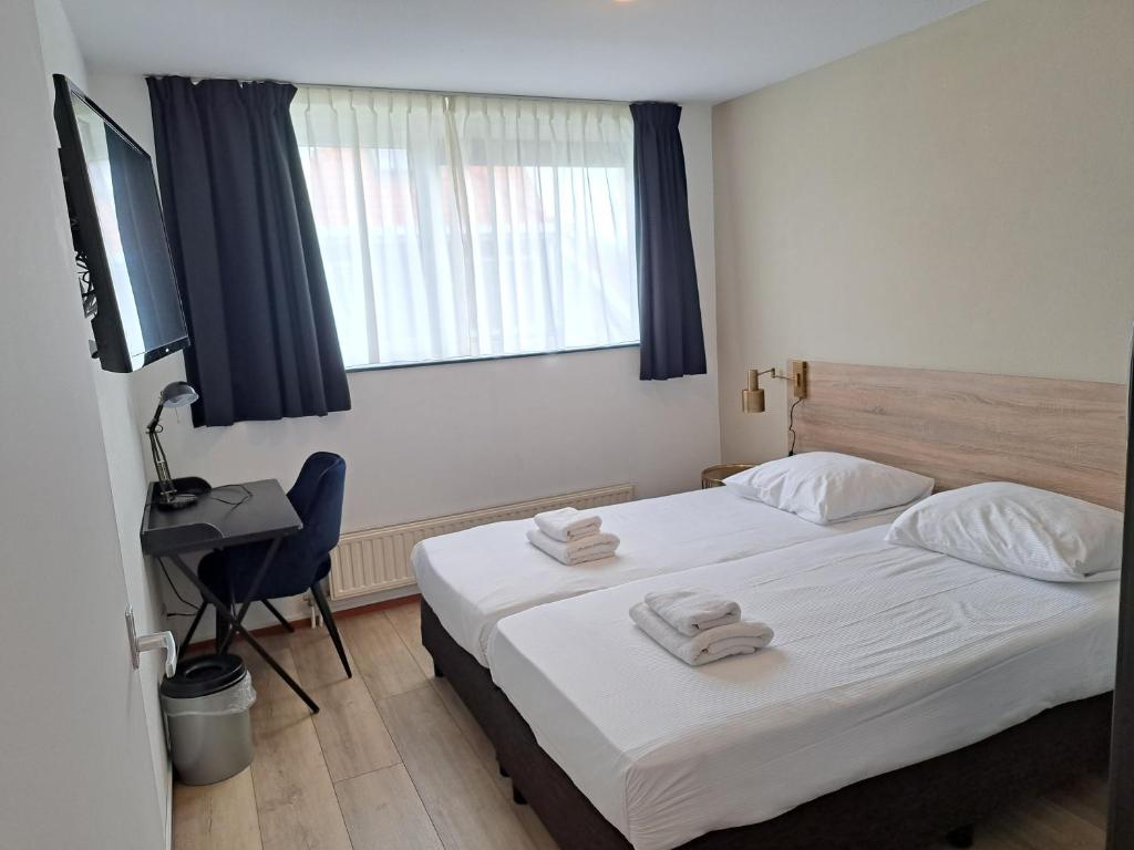 Postel nebo postele na pokoji v ubytování Seehotel Oostkapelle