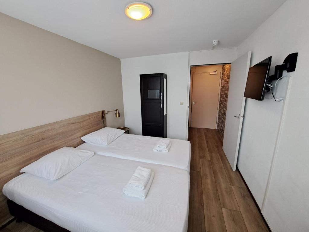 Postel nebo postele na pokoji v ubytování Seehotel Oostkapelle
