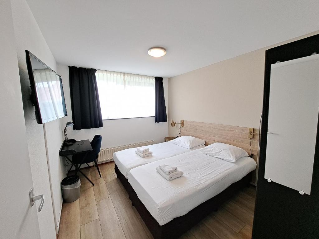 Postel nebo postele na pokoji v ubytování Seehotel Oostkapelle