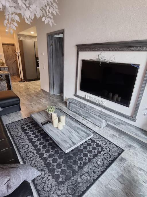 a living room with a flat screen tv and a fireplace at Ihana huoneisto Tallinnan Rotermannin keskustassa. in Tallinn