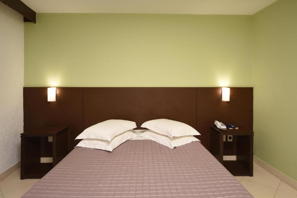 Postel nebo postele na pokoji v ubytování Hotel Dunamys Curitiba