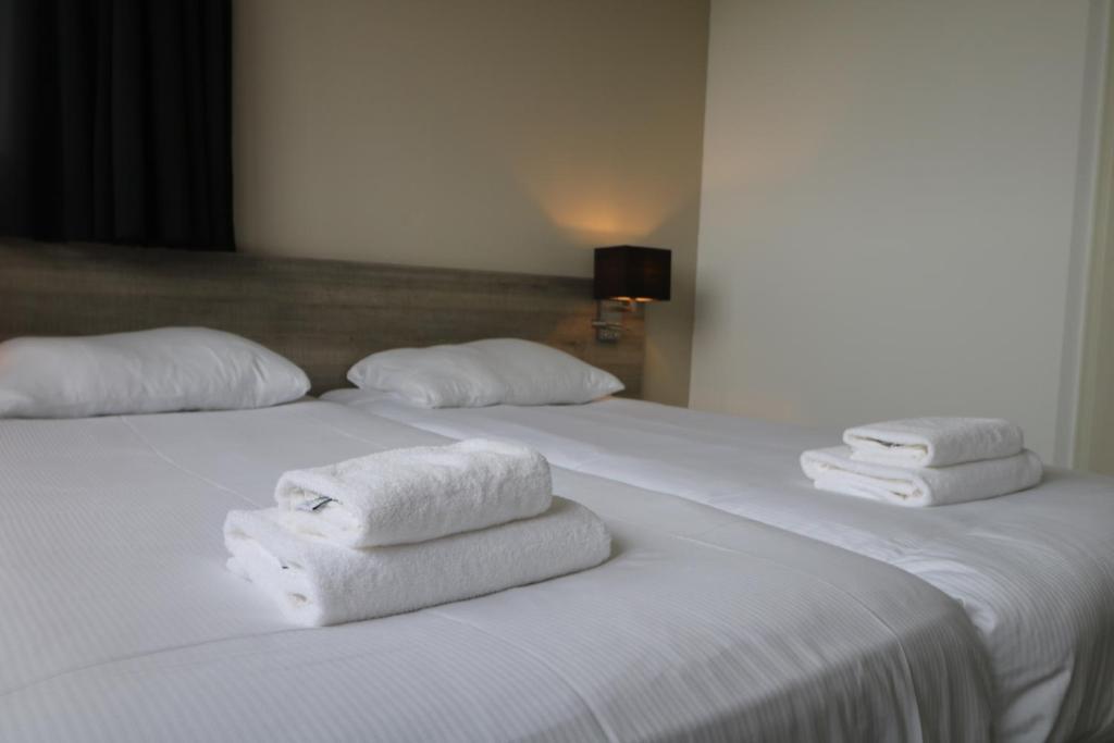 Postel nebo postele na pokoji v ubytování Seehotel Oostkapelle