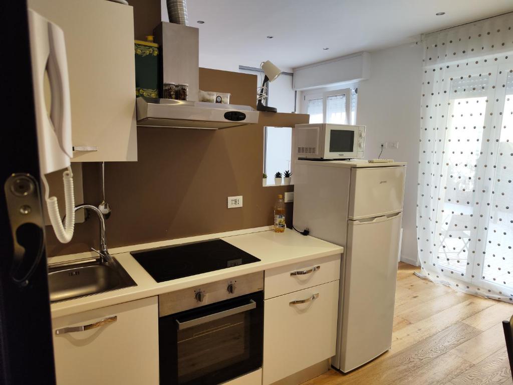 een keuken met een witte koelkast en een wastafel bij Ak holidays apartments 81 in Bologna