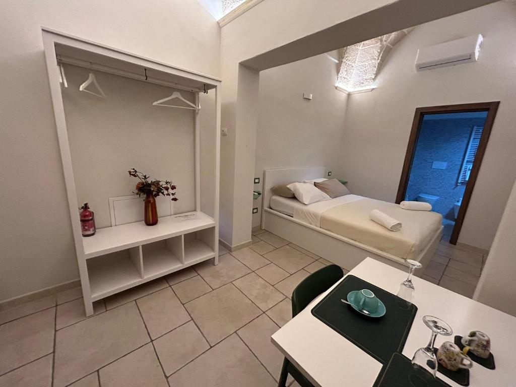 Cette petite chambre comprend un lit et une table. dans l'établissement 18 MQ, à Pulsano