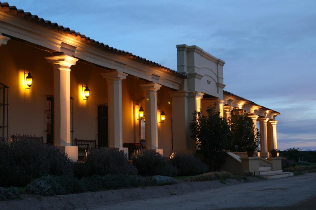 a large white building with lights on it at Altalaluna Hotel Boutique & Spa in Cafayate