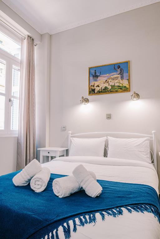 Postel nebo postele na pokoji v ubytování Neapolis 1897 Boutique Luxury Rooms