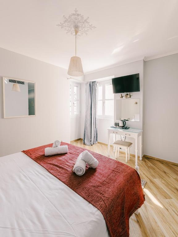 Postel nebo postele na pokoji v ubytování Neapolis 1897 Boutique Luxury Rooms