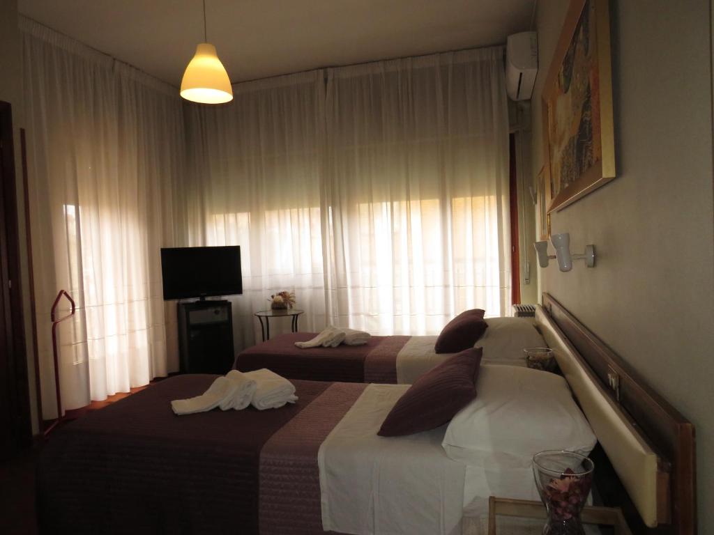 Postel nebo postele na pokoji v ubytování Hotel San Michele
