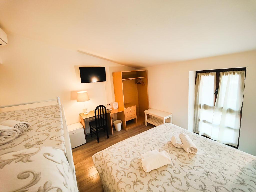 Postel nebo postele na pokoji v ubytování Albergo B&B Tenesi