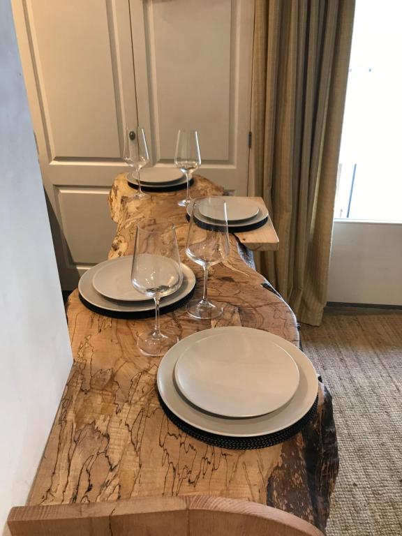a table with plates and wine glasses on it at Mooi Genieten Studio in Middelburg