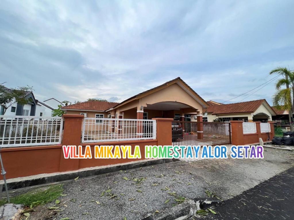 a house with a sign in front of it at Villa Mikayla Homestay - Alor Setar in Alor Setar