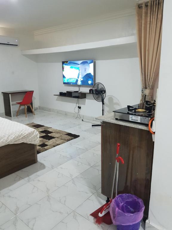 a living room with a tv on a wall at Andrea’s Home in Abuja