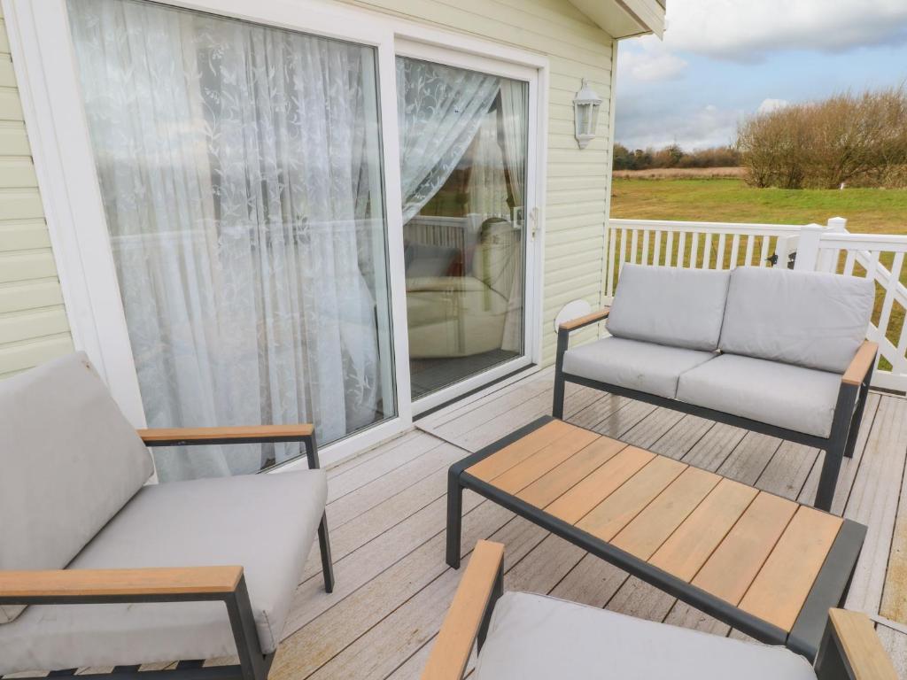 a porch with two chairs and a couch at Park Lane in Narberth