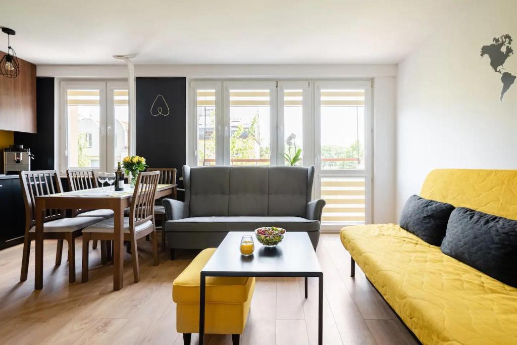 a living room with a couch and a table at The Best Location in Cracow for City Break in Kraków