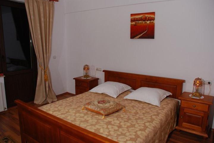 a bedroom with a bed with a tray on it at Pension Onelia in Gîrda de Sus