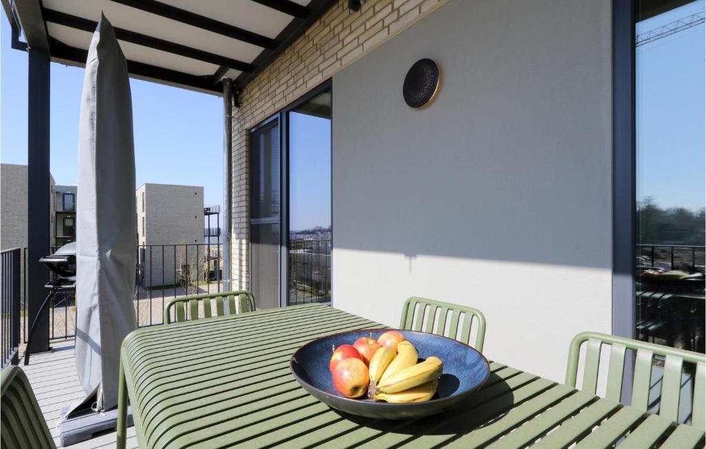 a bowl of fruit on a table on a balcony at Gorgeous Apartment In Lembruch-dmmer See With Kitchen in Lembruch