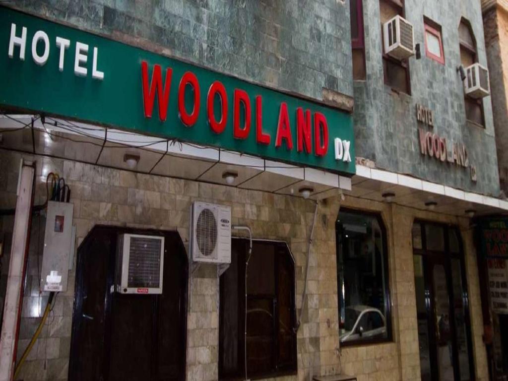 a hotel sign on the front of a building at Hotel Woodland Deluxe in New Delhi