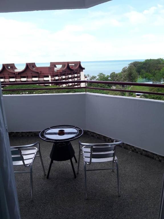 a patio with two chairs and a table on a balcony at Lovers Island homestay in Batu Ferringhi