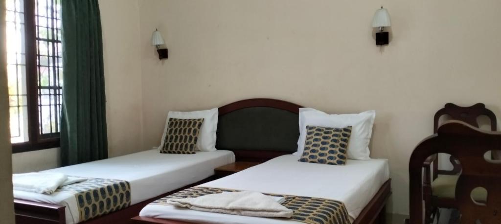 Postel nebo postele na pokoji v ubytování Elim Homestay Fort Kochi