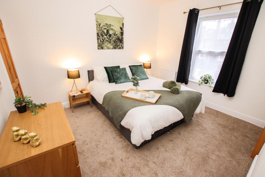 a bedroom with a large bed and a window at Modern, stylish city centre 3 bed property sleeps 6 in Lincoln