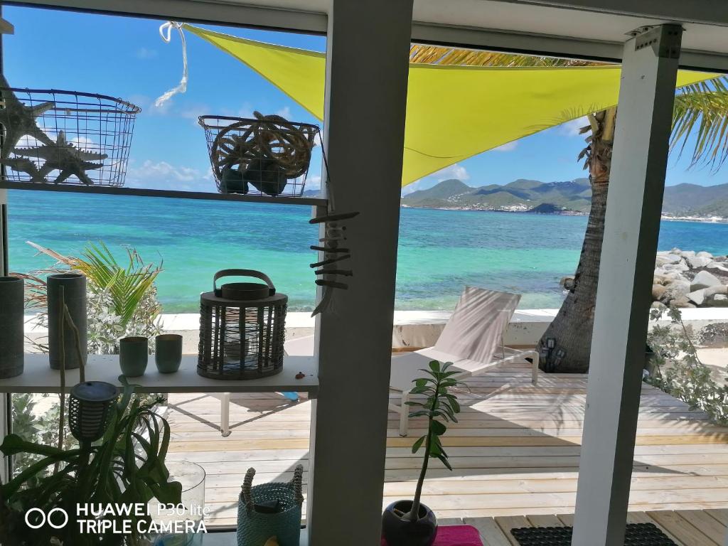 a view of the beach from the porch of a house at Love Beach Loft in Marigot