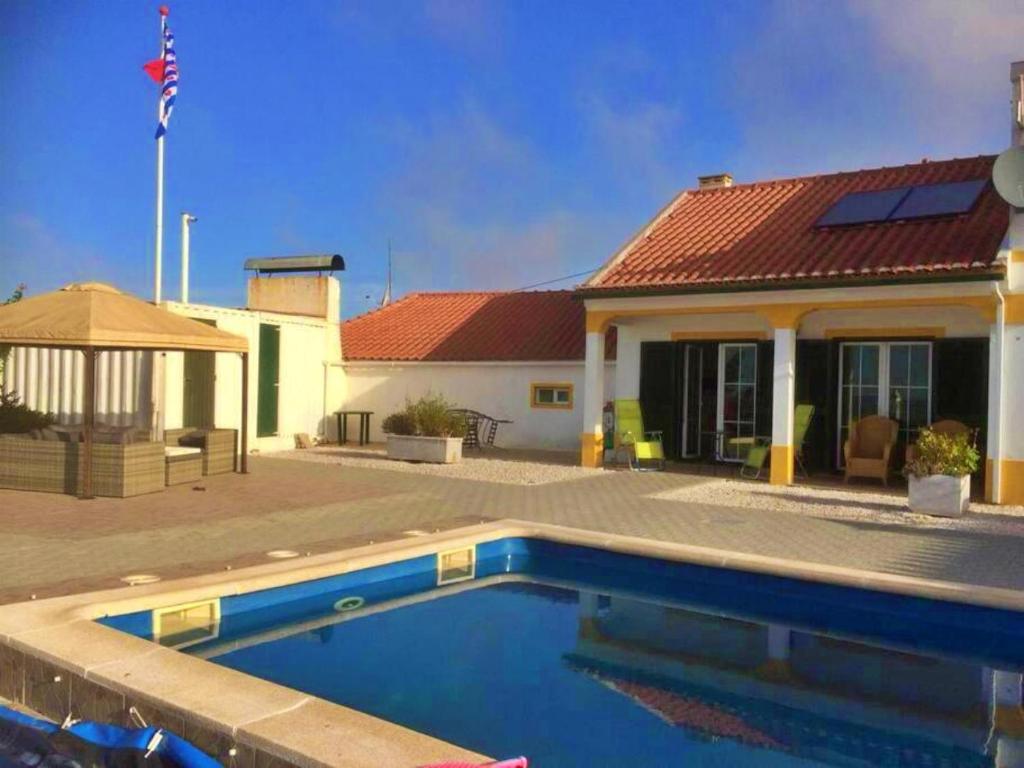 una casa con piscina frente a una casa en 4 Persoons Woning met Zwembad. Rustig gelegen., en Figueira e Barros