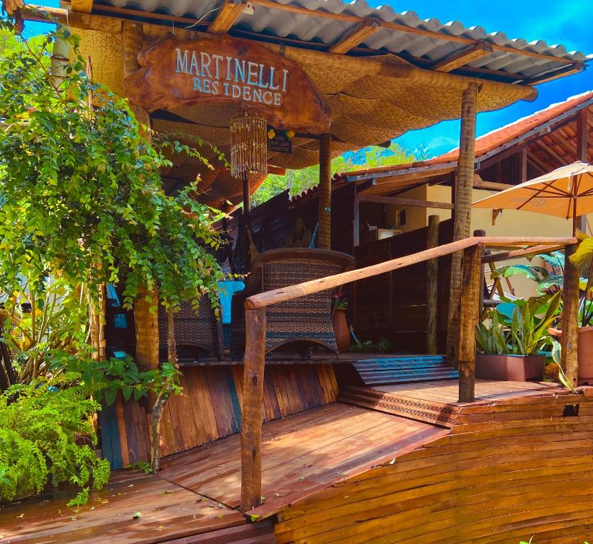 a wooden deck with a sign that reads merlincil less dance at Martinelli Residence in Fernando de Noronha