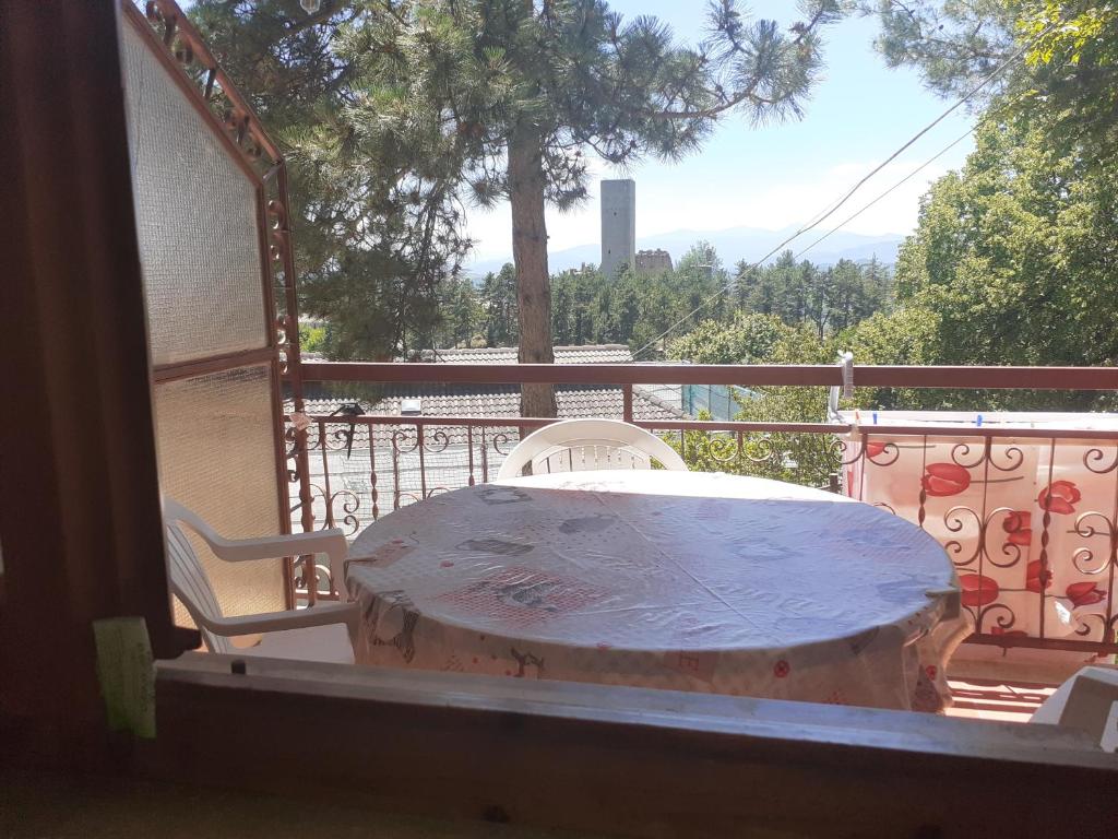 a table and chairs on a balcony with a view at Casetta Appennina (Bike Host) in Montefalcone Appennino