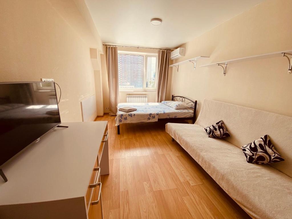 a living room with a couch and a bed at Let flat today in Kyiv