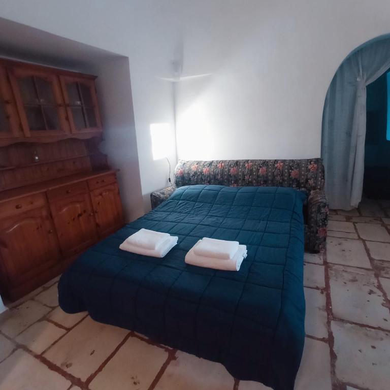 Łóżko lub łóżka w pokoju w obiekcie Villa Il Leccio - Trulli