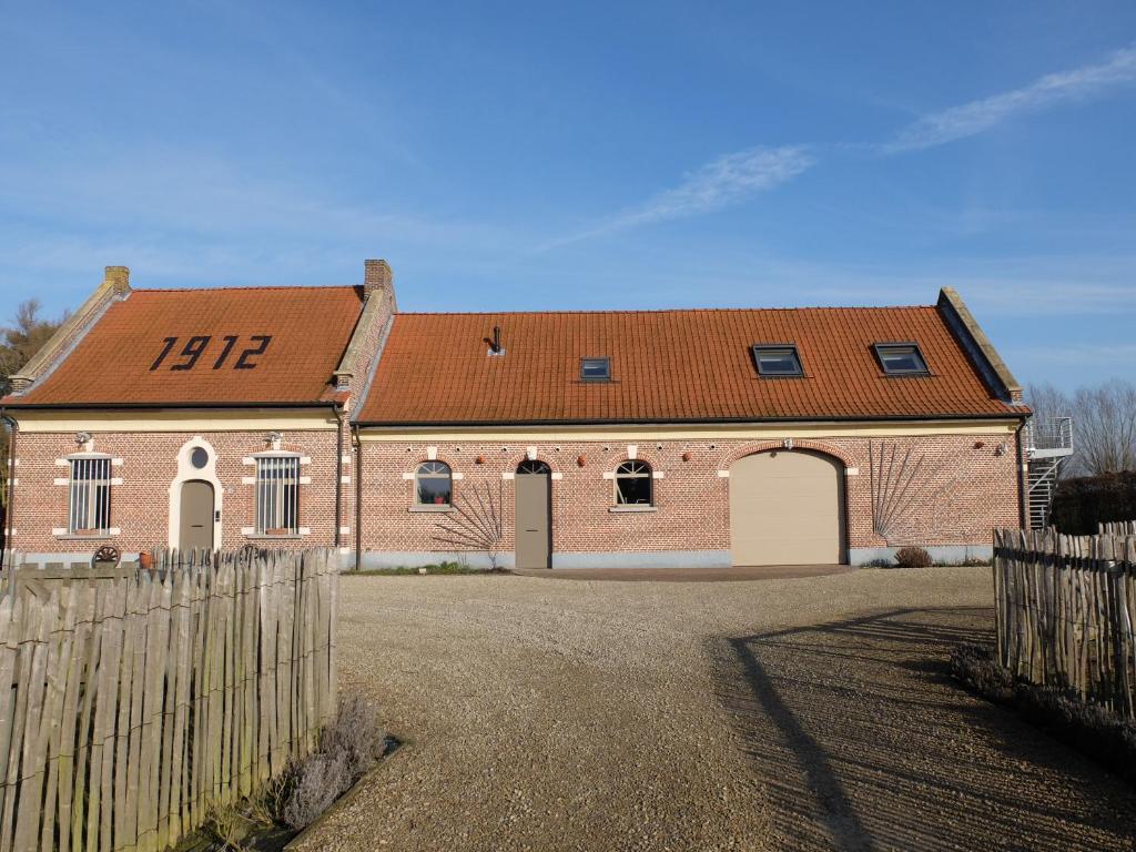 a large brick building with a red roof at Vakantiewoning Klavertje Lier in Lier