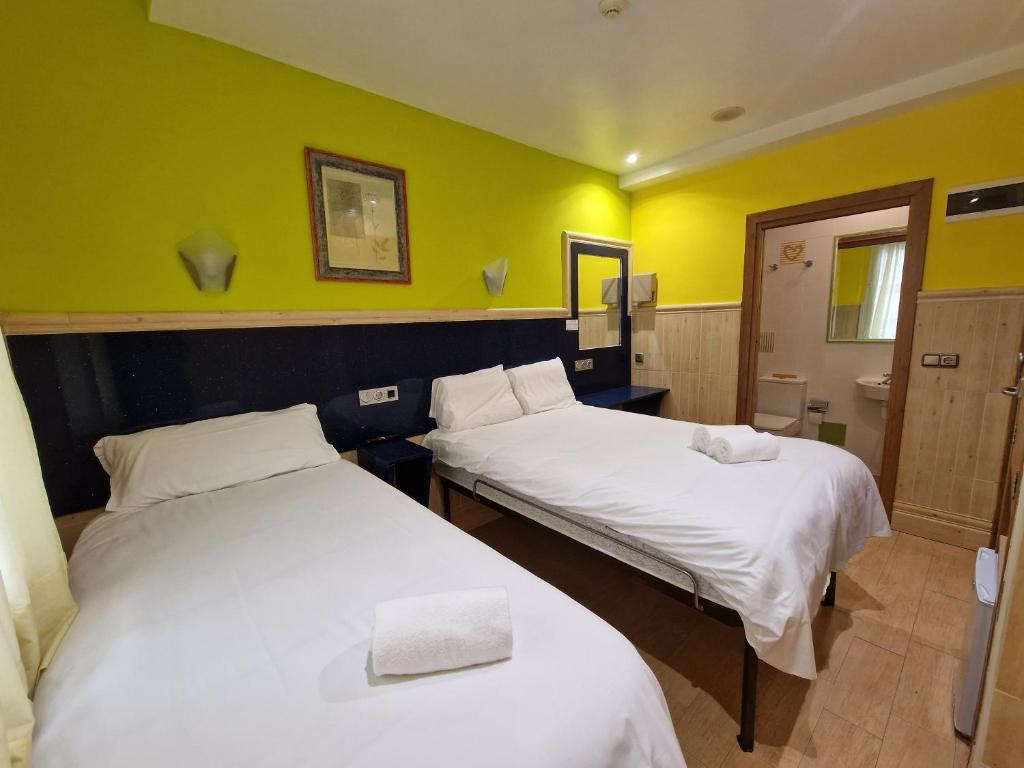 A bed or beds in a room at Pension Izar Bat Guesthouse
