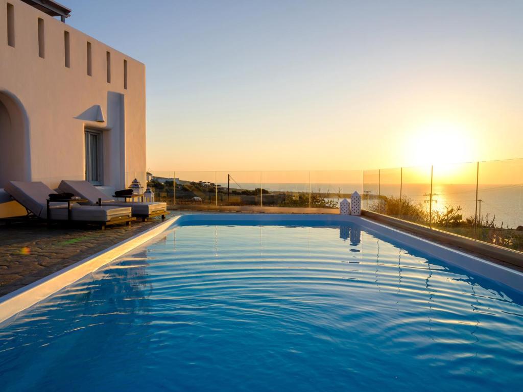 a swimming pool on the side of a house at Dreamland Ηouses in Oia