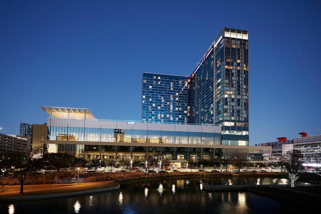 a tall building with a river in front of it at Marriott Marquis Houston in Houston