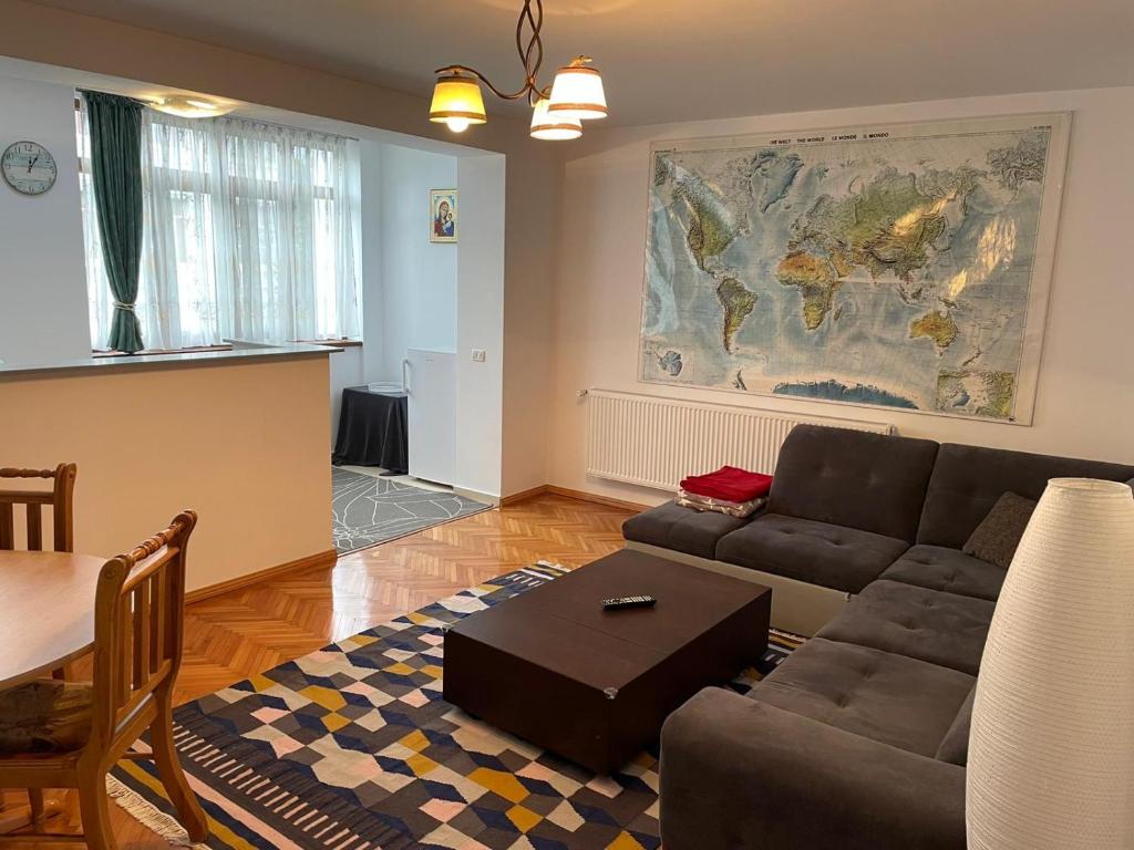 a living room with a couch and a map on the wall at Apartment Victoria in Victoria